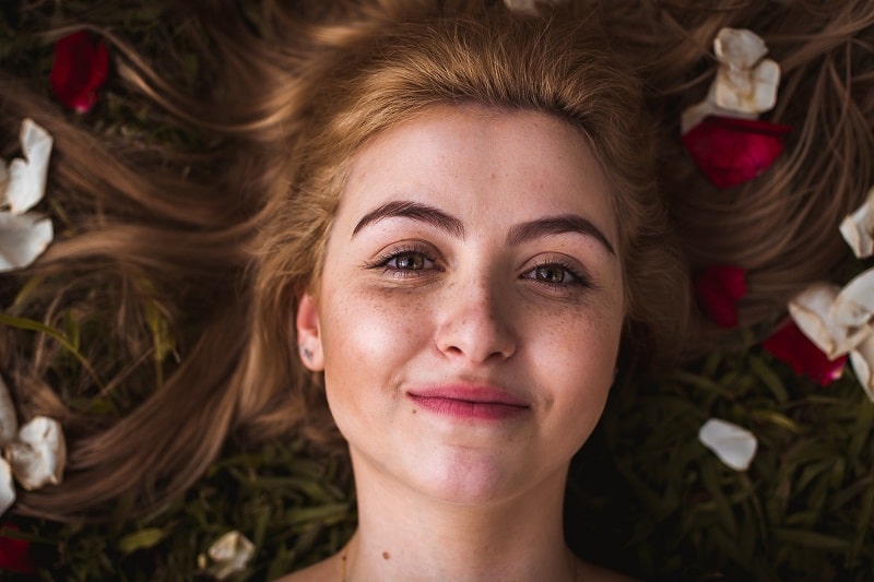 How the Secret Pro Laser Works Portrait of a Woman with Beautiful Skin and Flowers in Her Hair
