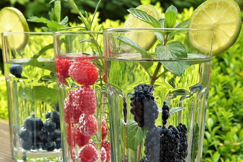 Non-Surgical Body Treatments Close Up of Three Glasses of Water with Fruit In Each Glass